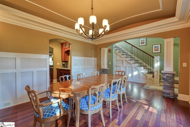 dining room featuring arched walkways, stairs, dark wood-type flooring, a decorative wall, and a chandelier