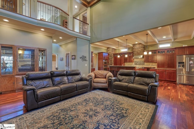 living area with crown molding, dark wood-type flooring, beam ceiling, recessed lighting, and a high ceiling