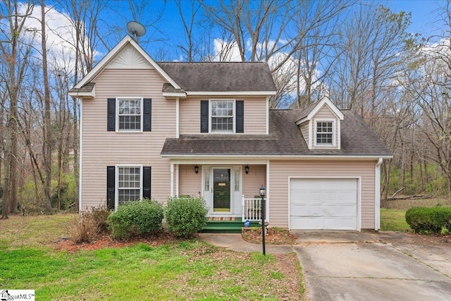 traditional home with a front yard, a porch, an attached garage, a shingled roof, and concrete driveway