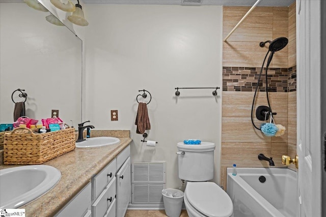 bathroom with visible vents, double vanity, a sink, bathing tub / shower combination, and toilet