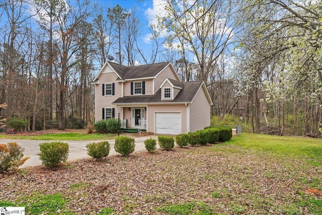 traditional-style house featuring a garage, a front yard, and driveway