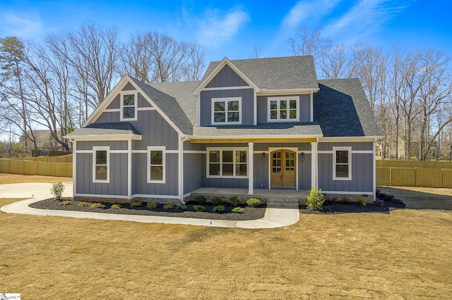 view of front of home with fence, a shingled roof, a front lawn, french doors, and board and batten siding