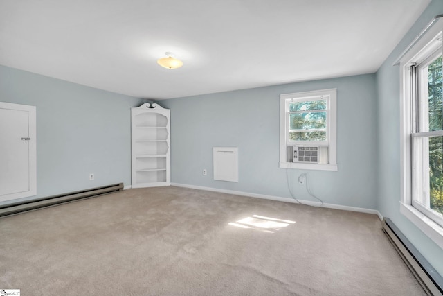 carpeted spare room with a wealth of natural light, baseboard heating, cooling unit, and baseboards