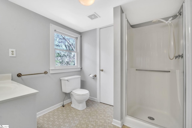 bathroom featuring visible vents, a shower stall, baseboards, toilet, and tile patterned floors