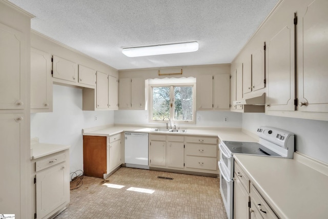 kitchen featuring white appliances, visible vents, a sink, under cabinet range hood, and a textured ceiling