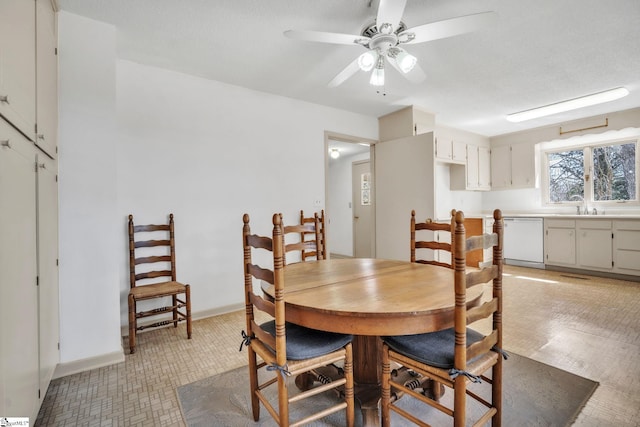 dining space with baseboards and ceiling fan