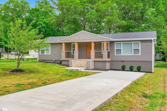 view of front of property featuring a front yard, fence, driveway, covered porch, and crawl space