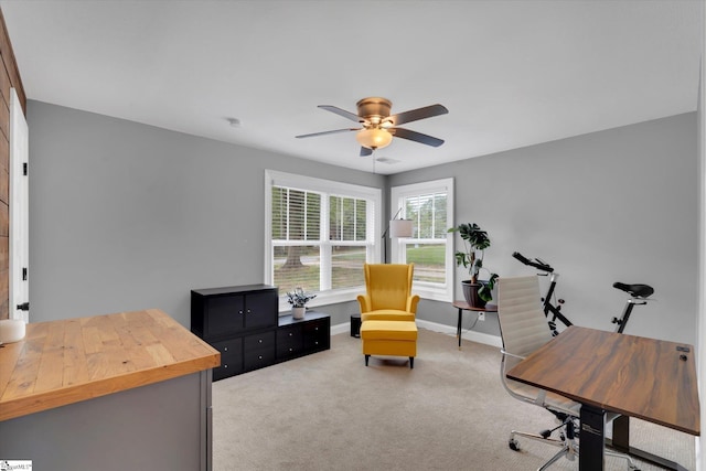 office with baseboards, carpet floors, and a ceiling fan