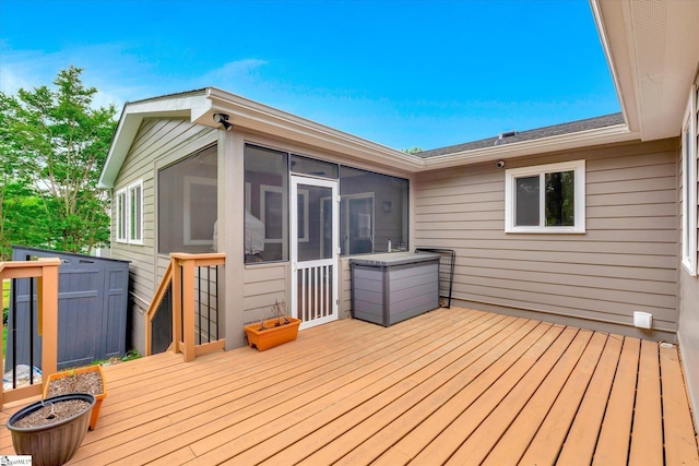 wooden deck with a sunroom