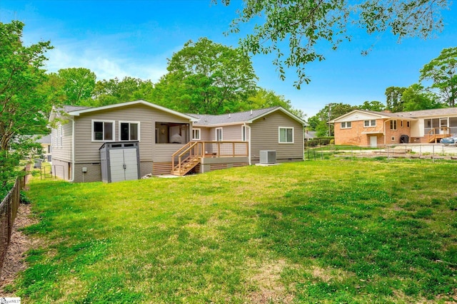 back of property with cooling unit, a yard, a fenced backyard, crawl space, and a deck