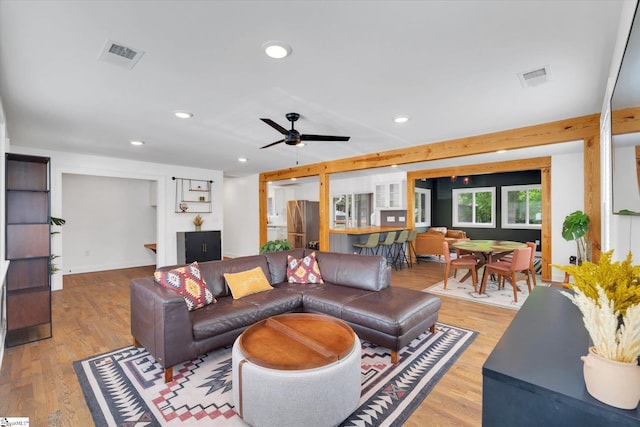 living room featuring visible vents, recessed lighting, and light wood-style floors