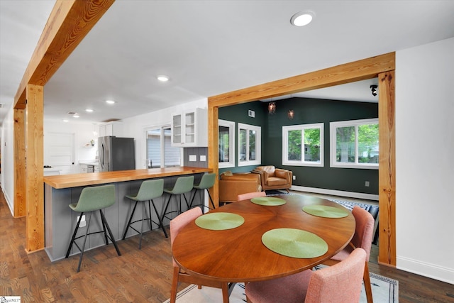 dining area with lofted ceiling, recessed lighting, and dark wood-style floors