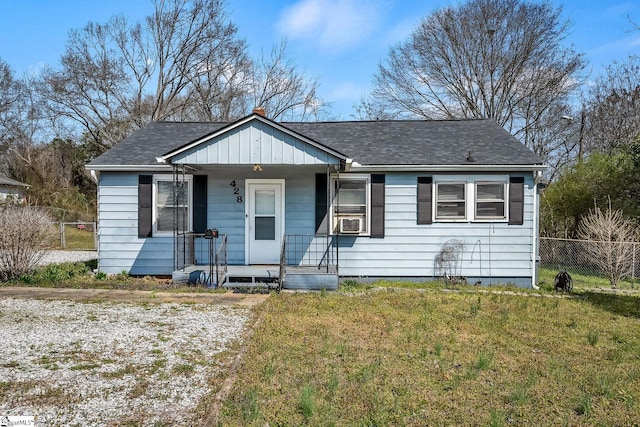 bungalow-style house with a shingled roof, a front lawn, fence, a porch, and cooling unit