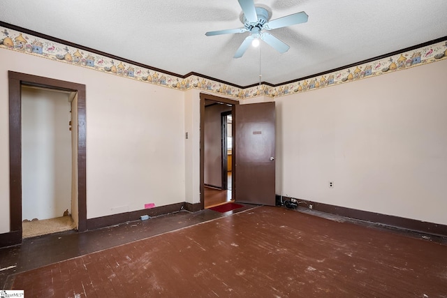 unfurnished room featuring ceiling fan, ornamental molding, baseboards, and a textured ceiling