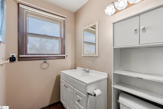 half bathroom with vanity and toilet