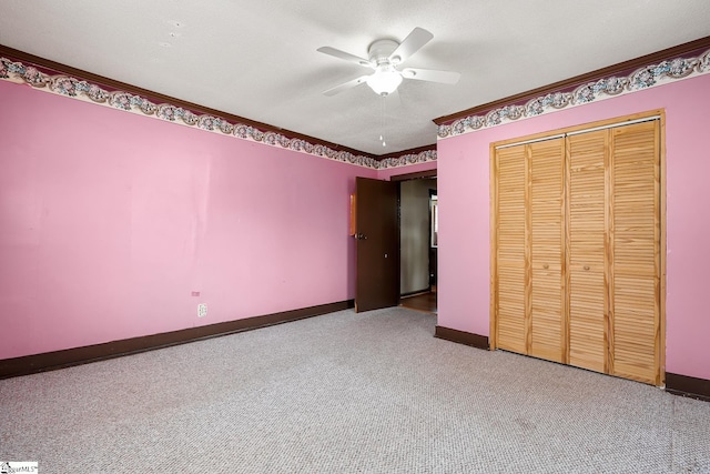 unfurnished bedroom with ceiling fan, baseboards, carpet, a closet, and a textured ceiling