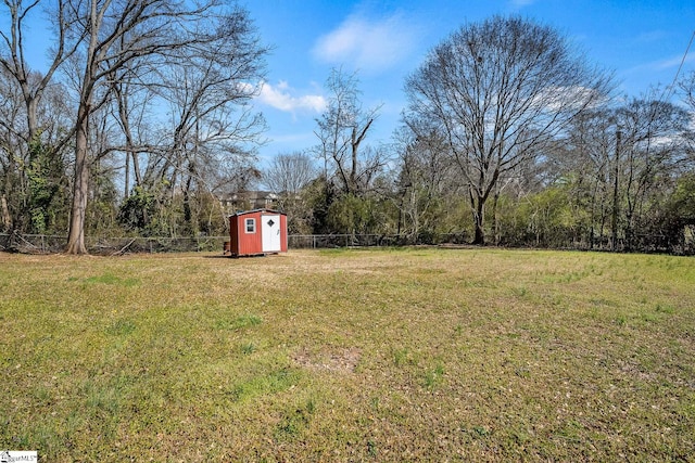 view of yard with a fenced backyard, a shed, and an outdoor structure