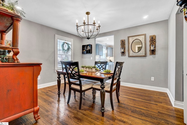 dining room featuring recessed lighting, baseboards, a notable chandelier, and dark wood-style floors