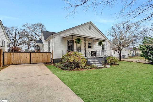 bungalow with a porch, fence, a front yard, and a gate