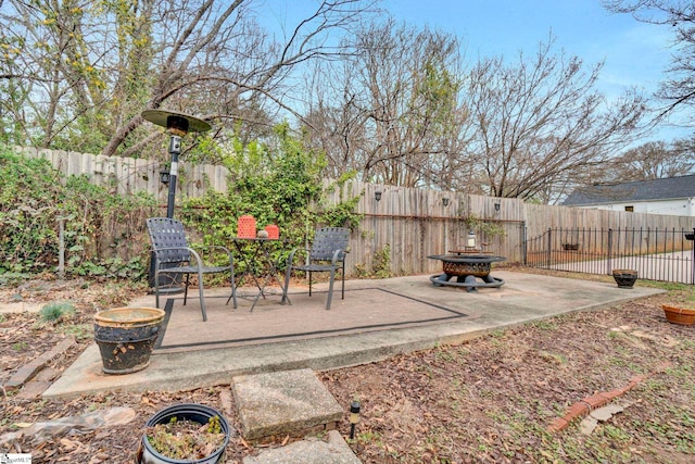 view of patio featuring a fenced backyard and an outdoor fire pit