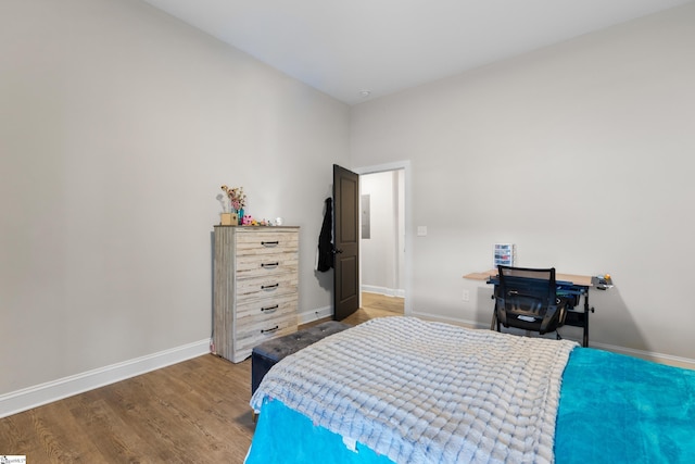 bedroom featuring baseboards and wood finished floors