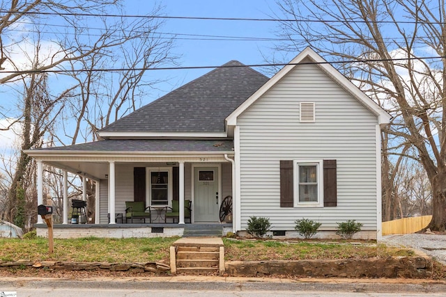 view of front of property with a porch and roof with shingles