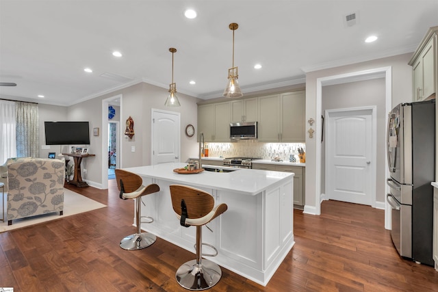 kitchen with dark wood-style flooring, light countertops, visible vents, and appliances with stainless steel finishes