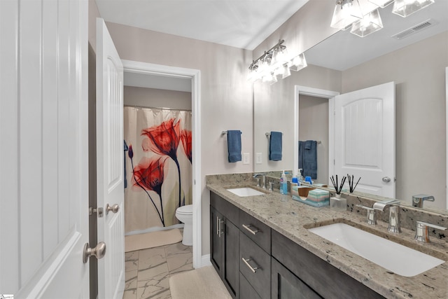 bathroom with toilet, visible vents, marble finish floor, and a sink