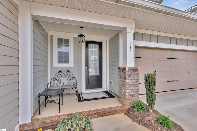 view of exterior entry featuring driveway