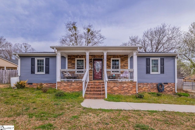 view of front of house with crawl space, covered porch, a front yard, and fence