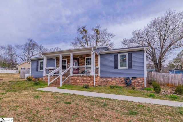 bungalow-style home featuring crawl space, covered porch, a front yard, and fence