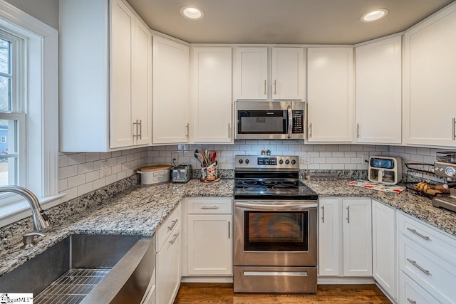 kitchen featuring a sink, white cabinetry, and stainless steel appliances