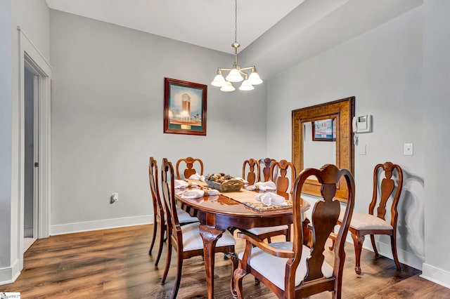 dining room with wood finished floors, baseboards, and a chandelier