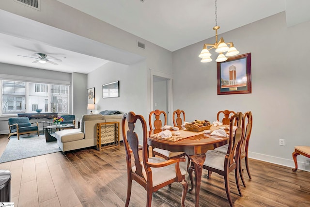 dining area with visible vents, baseboards, and wood finished floors