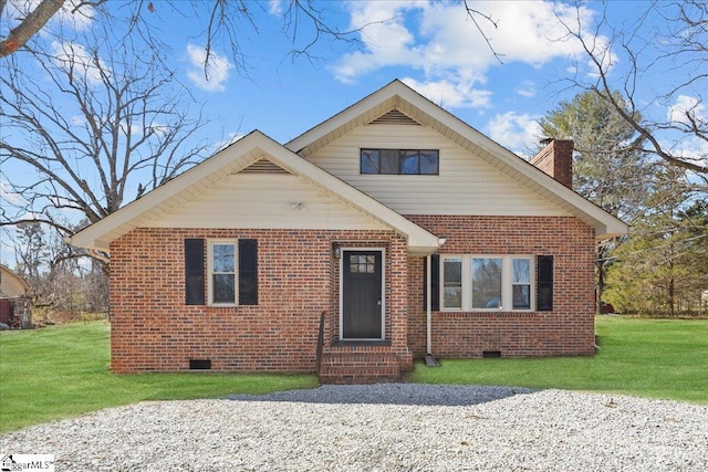 view of front of property featuring a front yard, a chimney, brick siding, and crawl space