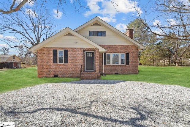 view of front of home featuring brick siding, a front lawn, entry steps, a chimney, and crawl space