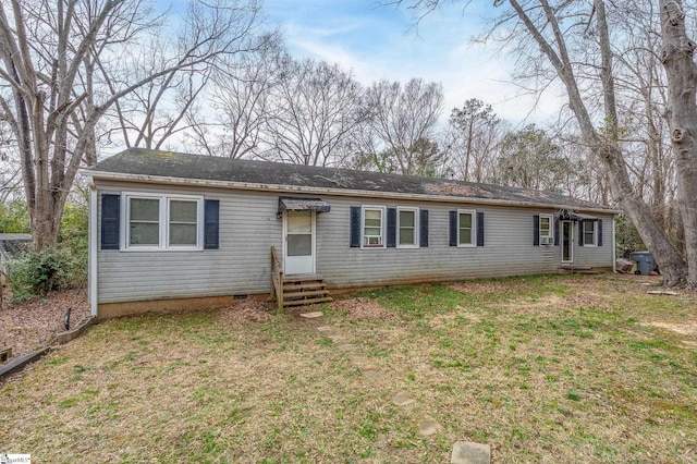 ranch-style house with entry steps and a front lawn