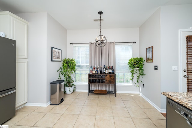 dining room featuring light tile patterned floors, visible vents, baseboards, and an inviting chandelier