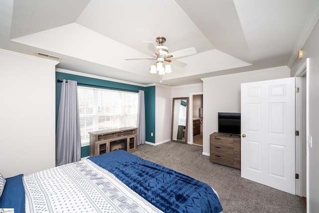 bedroom with baseboards, visible vents, a tray ceiling, ornamental molding, and carpet flooring