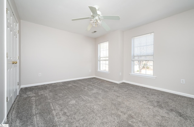 spare room with visible vents, carpet flooring, a ceiling fan, and baseboards