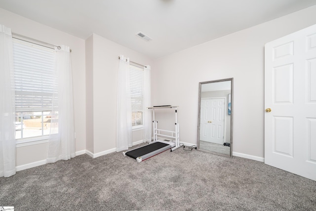 workout room with visible vents, baseboards, and carpet