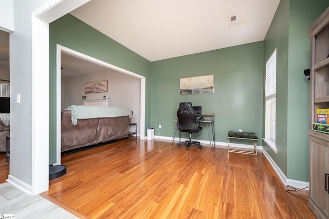 unfurnished bedroom with visible vents, baseboards, and wood finished floors