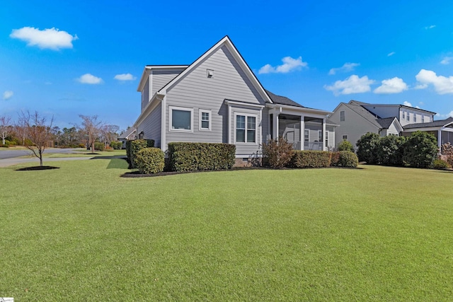 view of front of property with crawl space, a front yard, and a sunroom