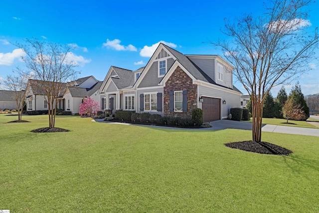 view of front of house featuring stone siding, driveway, a front yard, and an attached garage