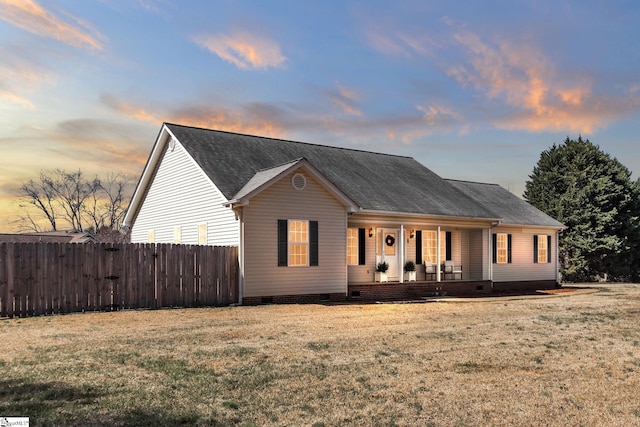 view of front facade with crawl space, a porch, a front lawn, and fence