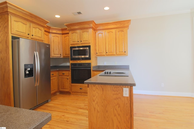 kitchen with dark countertops, visible vents, appliances with stainless steel finishes, a peninsula, and light wood-style floors