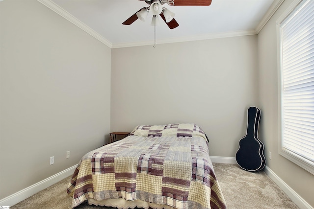 carpeted bedroom with baseboards, ornamental molding, and a ceiling fan