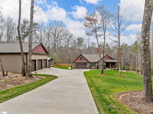 view of front of property with a front lawn, stone siding, and driveway