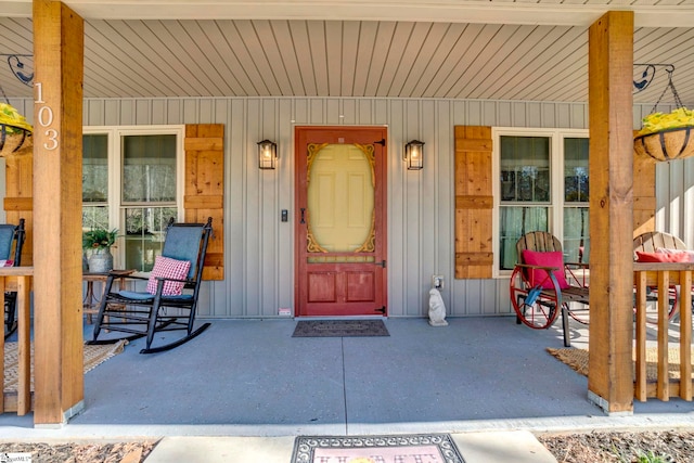 entrance to property with a porch and board and batten siding