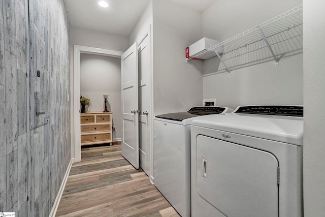 laundry area featuring baseboards, washing machine and dryer, laundry area, recessed lighting, and light wood-style flooring